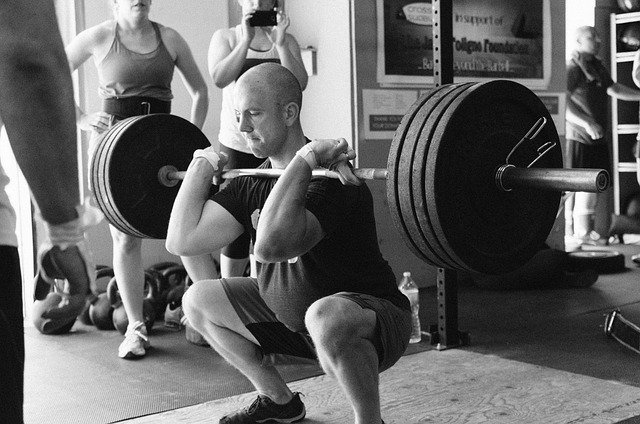 Why do some people vomit when lifting heavy weights?
