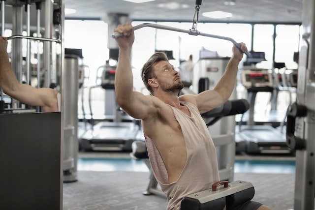 Why do I feel lat pulldowns in my chest?
