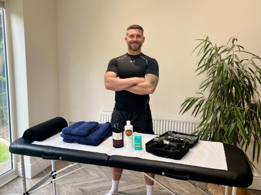 Lee, mobile sports massage therapist in Leicestershire, with massage table and kit